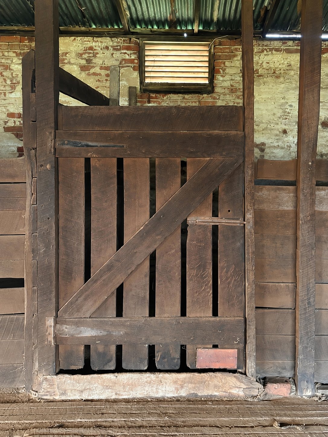 A weathered timber stable door at Guildford Farm